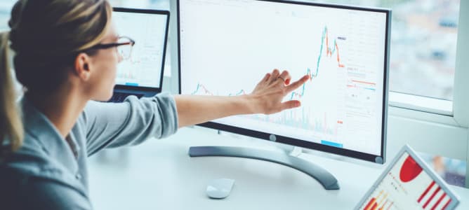 Business woman study financial market to calculate possible risks and profits.