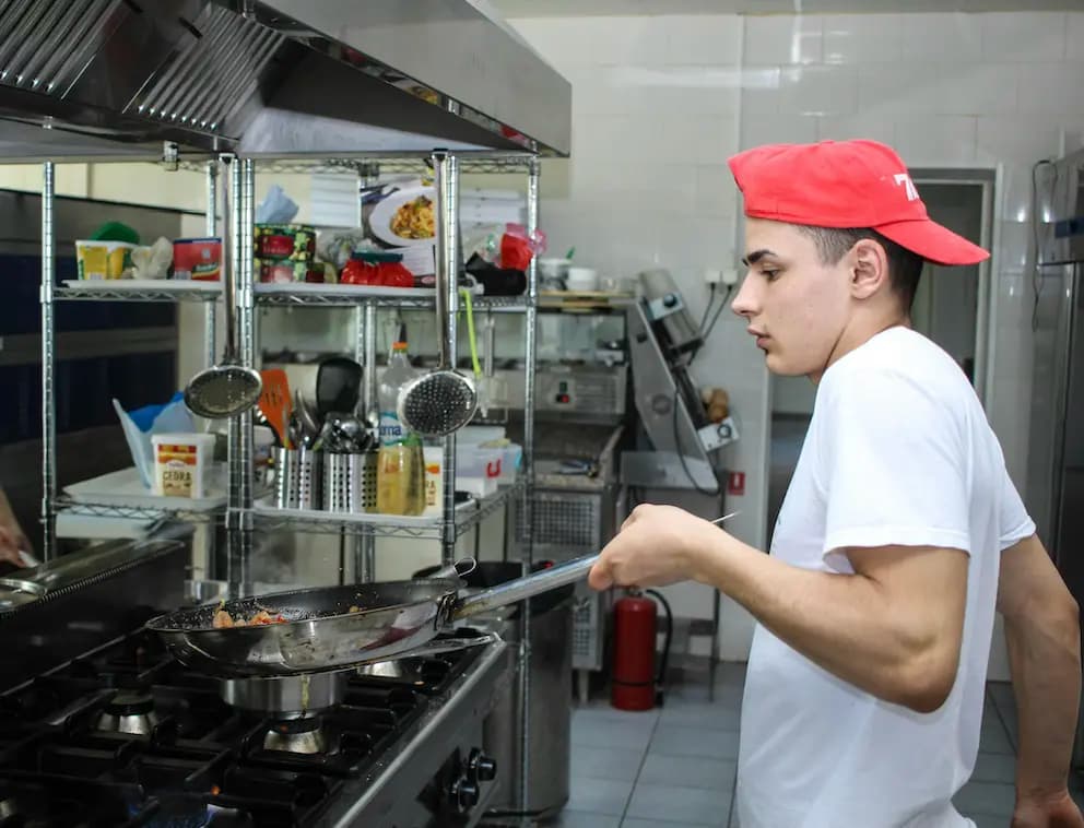 line cook making food at a restaurant in the kitchen