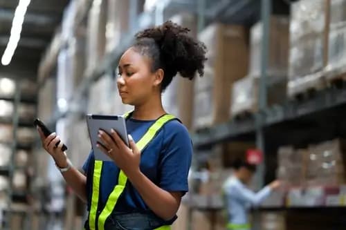 warehouse worker managing inventory with a POS system