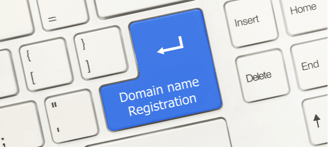 Close-up view on white conceptual keyboard - Domain name registration (blue key)