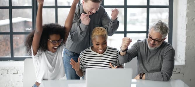 Members of a marketing team celebrate upon receiving news that their positioning statement has been approved