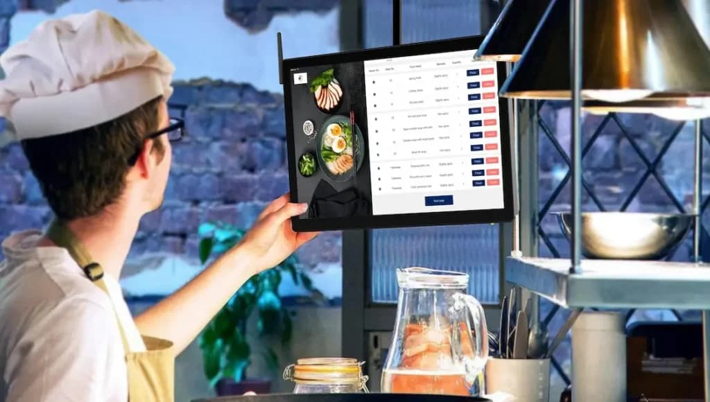 chef at an asian food restaurant taking an order from a KDS